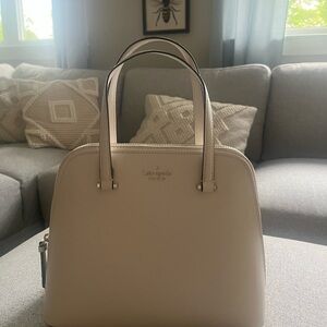 Kate Spade.Never used, bone white,gold logo. Strap is long enough for crossbody